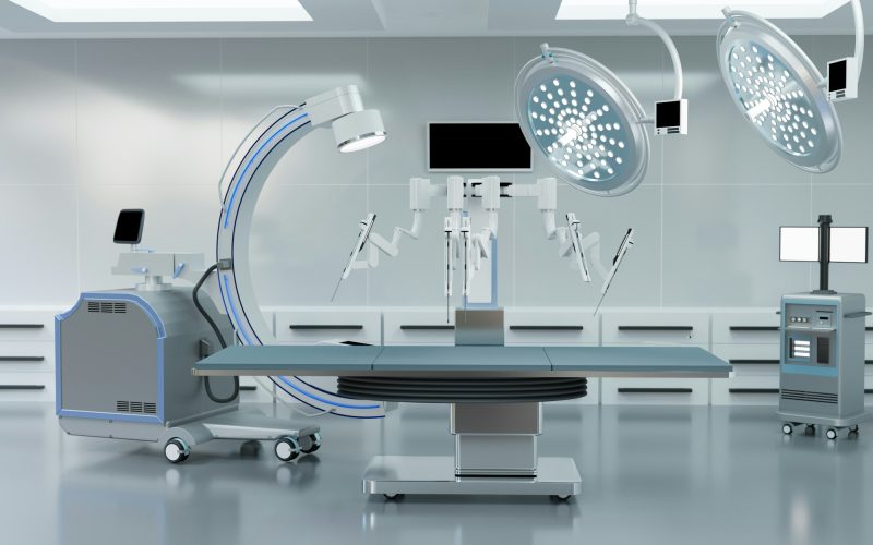 clean operating room, robot with C arm and medical equipment