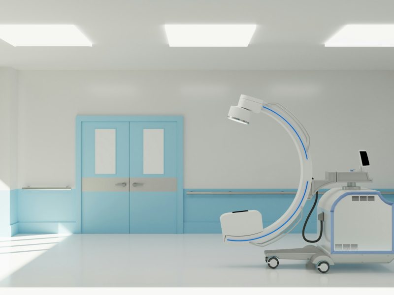 clean operating room with C arm and medical equipment