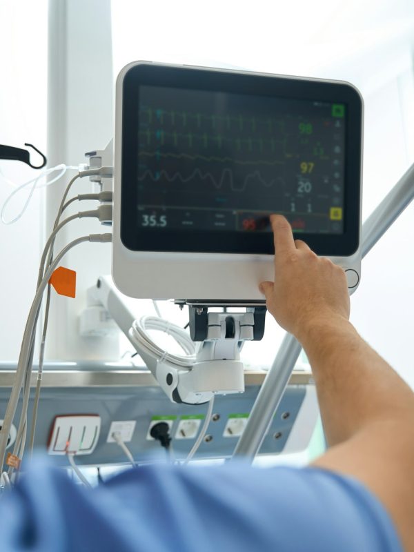 Close up photo of doctor looking at medical device