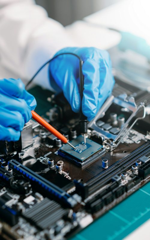 The technician is putting the CPU on the socket of the computer motherboard.